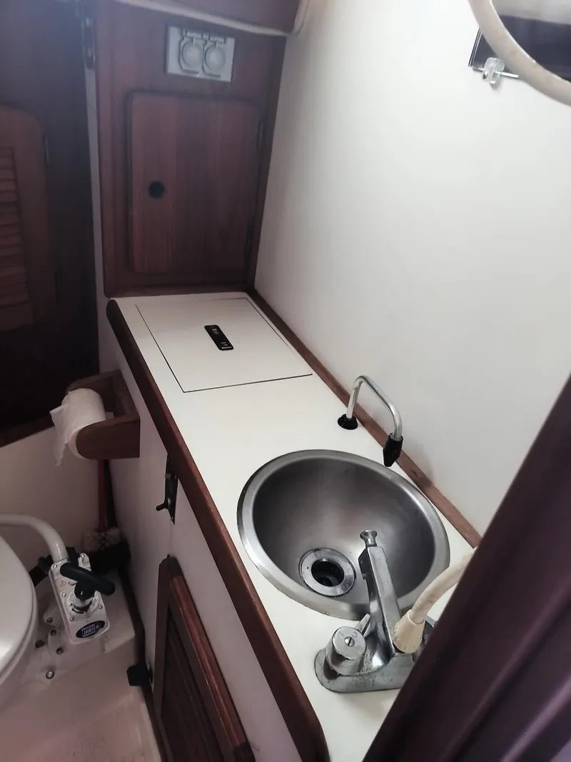 Slide: The Image of 1983 Morgan 32-3 yacht bathroom with sink, faucet, and toilet. - 23