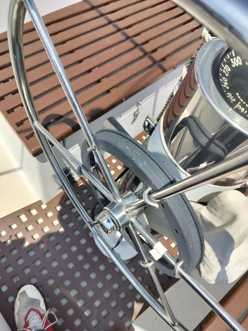 Slide: The Image of Steering wheel and compass on 1983 Morgan 32-3 sailboat deck. - 3