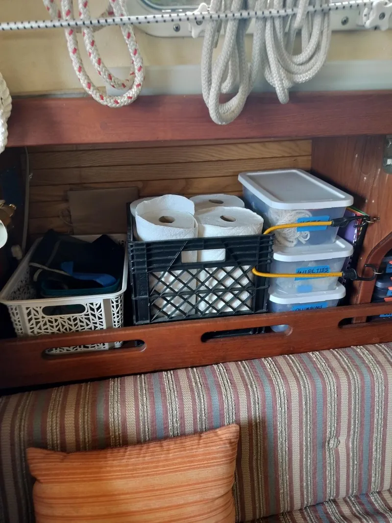 Slide: The Image of Storage area in a 1983 Morgan 32-3 boat with organized supplies and ropes. - 4