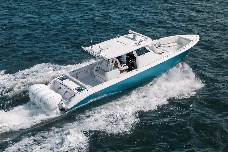 The Image of 2022 Everglades 395cc boat cruising on open water, showcasing sleek design and powerful engines. - 0