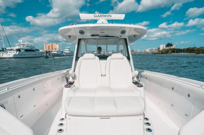 Slide: The Image of 2022 Everglades 395cc boat on water, featuring white seating and Garmin equipment. - 31