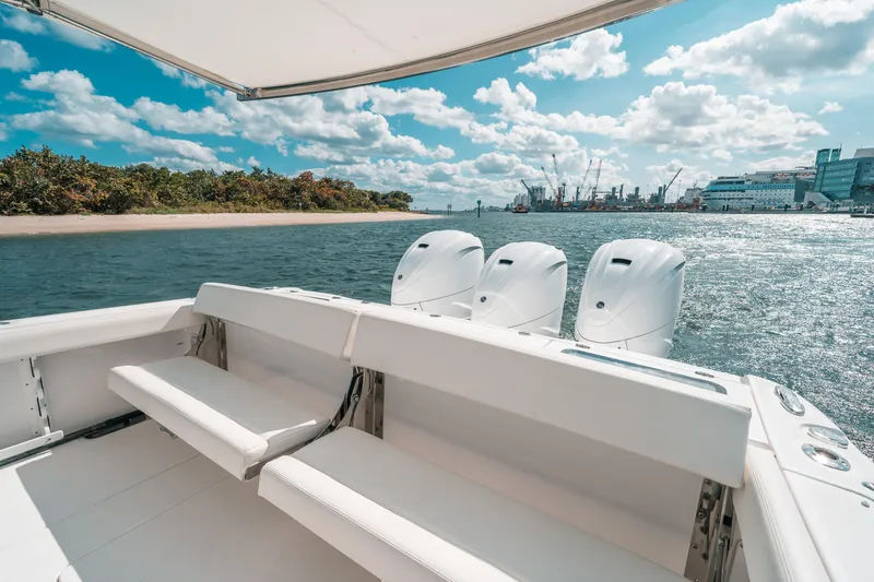 Slide: The Image of Luxury Everglades 395cc boat, 2022 model, cruising on a sunny day with scenic waterfront views. - 36