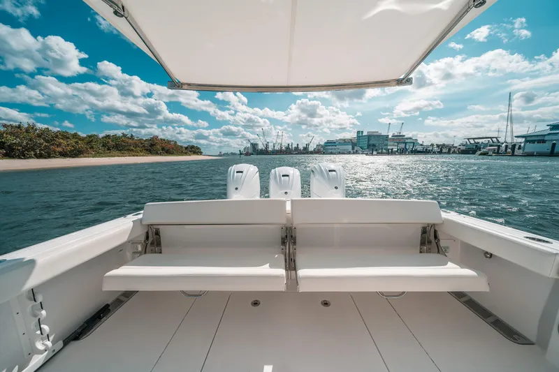 Slide: The Image of 2022 Everglades 395cc boat with dual engines, cruising on a sunny day. - 38