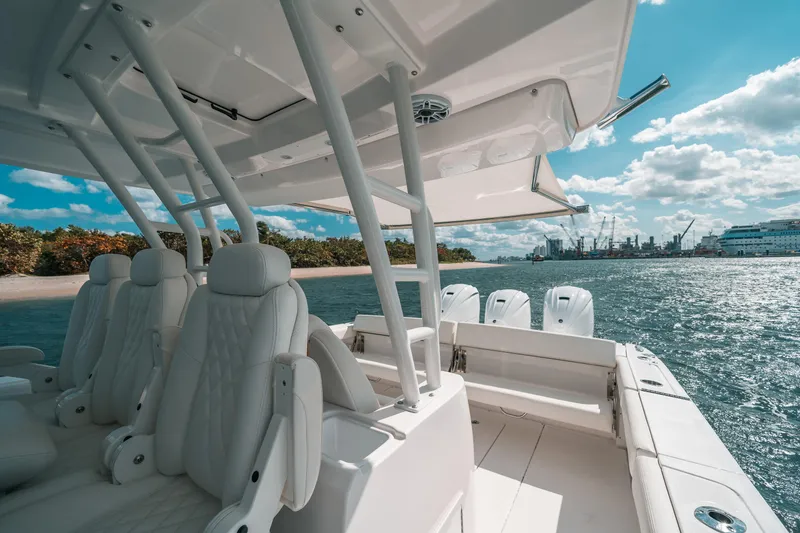 Slide: The Image of Luxury Everglades 395cc boat interior, 2022 model, with plush seating and ocean view. - 39