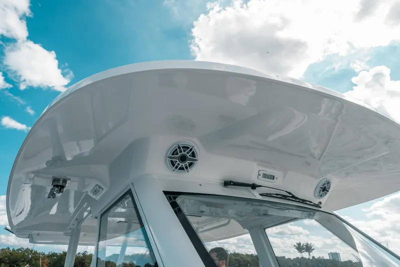 Slide: The Image of 2022 Everglades 395cc boat with sleek design and modern features under a bright sky. - 43