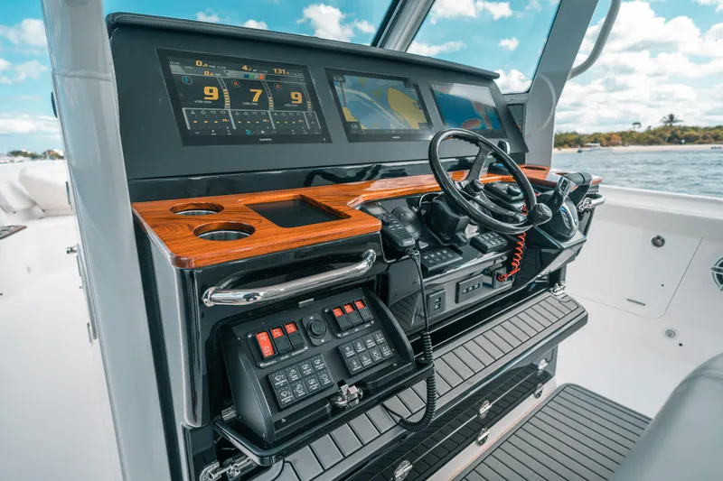 Slide: The Image of 2022 Everglades 395cc boat dashboard with advanced controls and navigation screens. - 49
