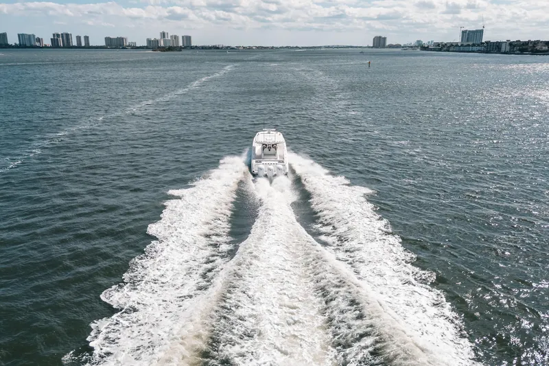 Slide: The Image of Aerial view of 2022 Everglades 395cc boat cruising on open water. - 9