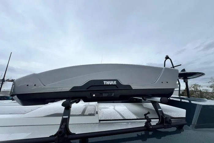 Slide: The Image of Thule roof box mounted on a 2024 Sargo 36 under a cloudy sky. - 20
