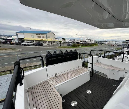 Slide: The Image of 2024 Sargo 36 yacht deck with seating, docked near a marina. - 25