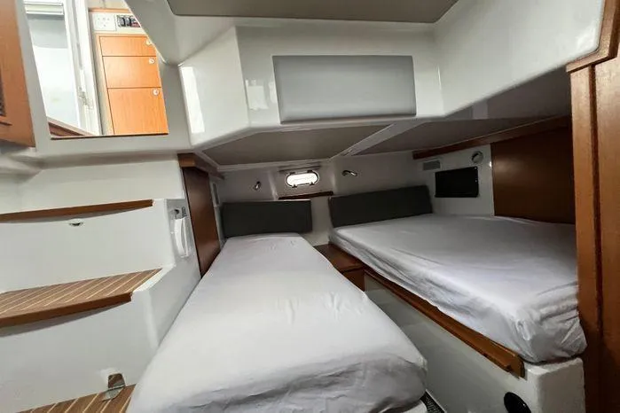 Slide: The Image of 2024 Sargo 36 cabin interior with twin beds and wooden accents. - 28