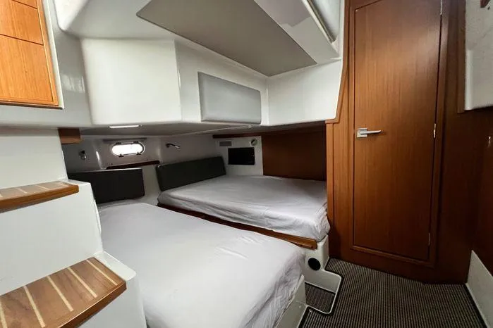 Slide: The Image of 2024 Sargo 36 cabin interior with twin beds, wooden accents, and modern design. - 29