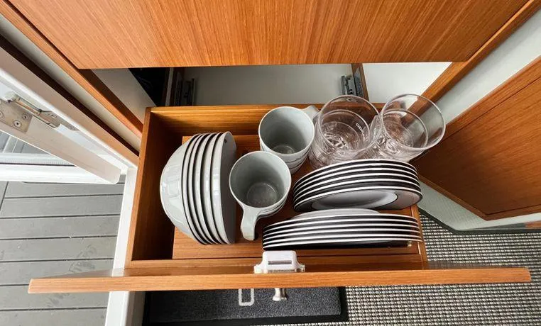 Slide: The Image of Open drawer with neatly stacked dishes and glasses in a Sargo 36, 2024 model. - 30