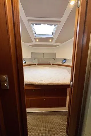 Slide: The Image of 2024 Sargo 36 cabin interior with bed, skylight, and wooden accents. - 35