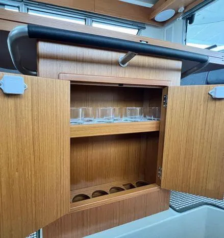 Slide: The Image of 2024 Sargo 36 interior with wooden cabinet and glass storage. - 38