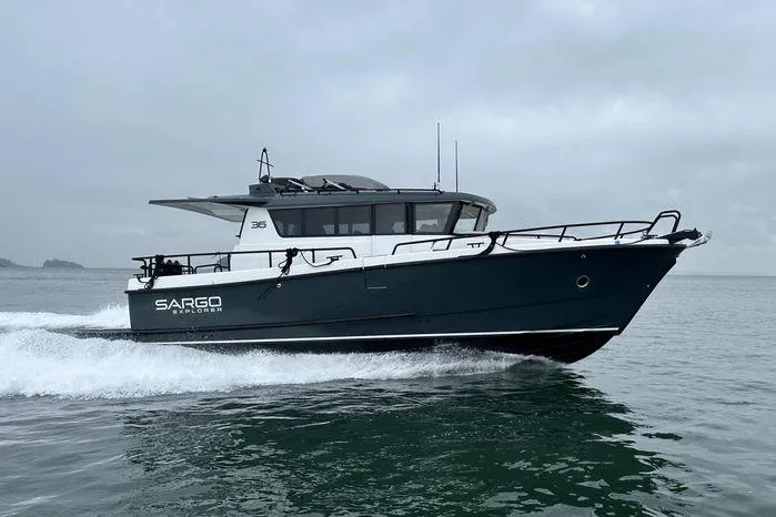 Slide: The Image of 2024 Sargo 36 boat cruising on open water under cloudy skies. - 4