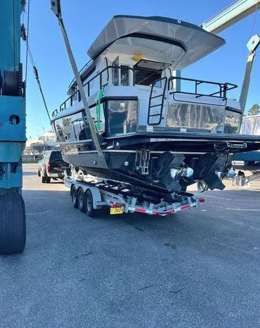 Slide: The Image of 2024 Sargo 36 boat on trailer, ready for transport at a marina. - 6