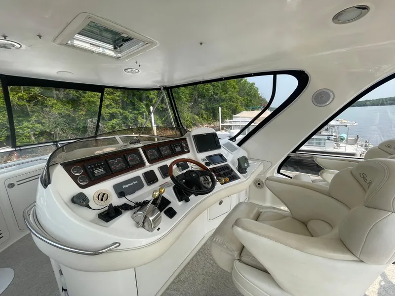 Slide: The Image of 2001 Sea Ray 480 Sedan Bridge helm with modern controls and panoramic view. - 13