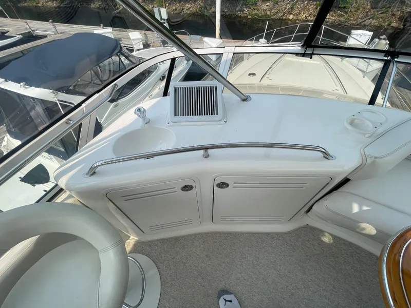 Slide: The Image of 2001 Sea Ray 480 Sedan Bridge helm area with sink and storage cabinets. - 20
