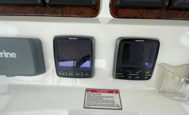 Slide: The Image of Control panel of a 2001 Sea Ray 480 Sedan Bridge with Raymarine displays. - 23