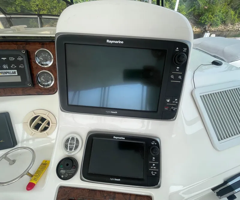 Slide: The Image of Control panel of a 2001 Sea Ray 480 Sedan Bridge with Raymarine displays. - 25