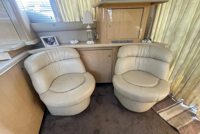 Slide: The Image of Luxurious interior of 2001 Sea Ray 480 Sedan Bridge with plush beige seating. - 29