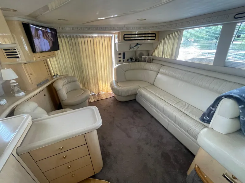 Slide: The Image of Luxurious interior of 2001 Sea Ray 480 Sedan Bridge yacht with plush seating and entertainment system. - 30