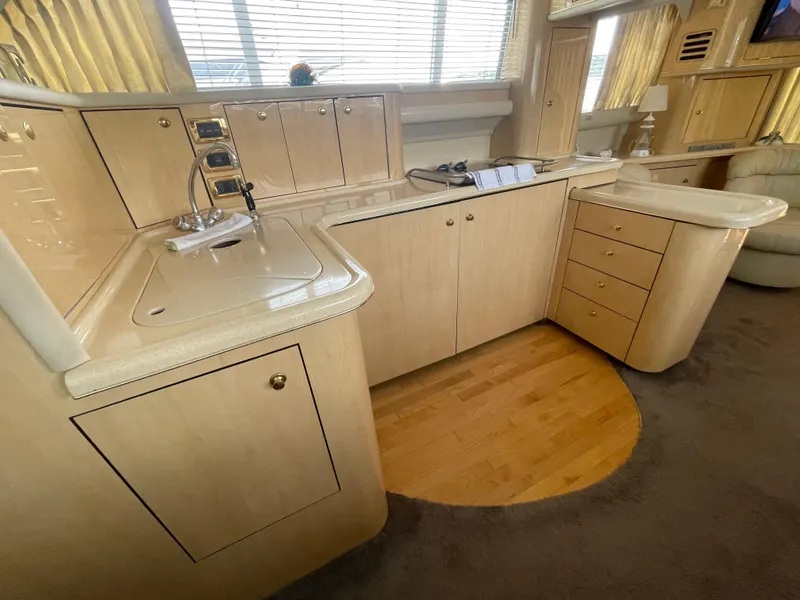Slide: The Image of Luxurious kitchen interior of 2001 Sea Ray 480 Sedan Bridge yacht with wooden cabinetry. - 35