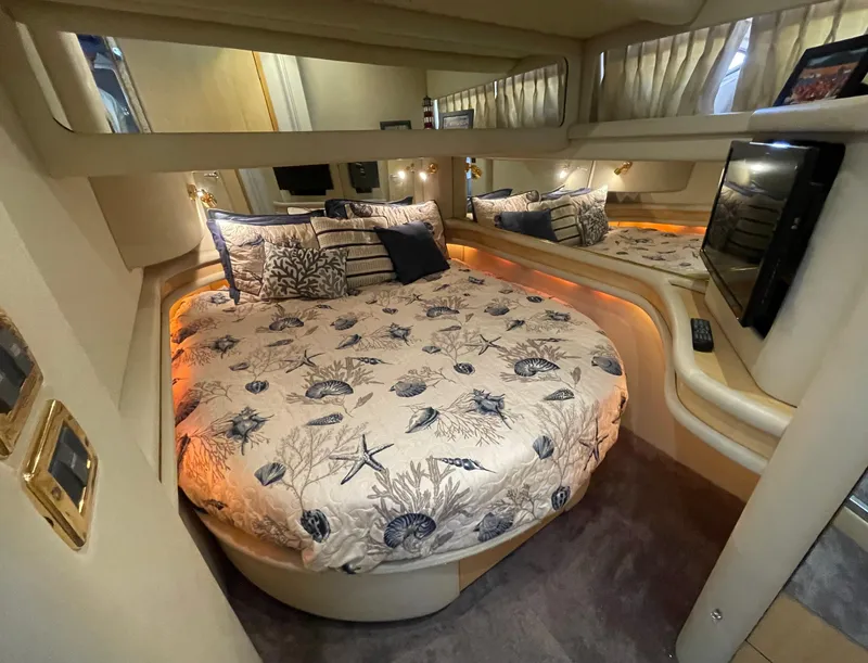 Slide: The Image of Luxurious bedroom interior of 2001 Sea Ray 480 Sedan Bridge yacht with nautical-themed bedding. - 42
