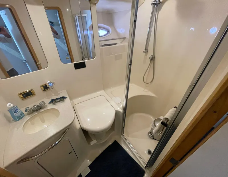Slide: The Image of Bathroom interior of 2001 Sea Ray 480 Sedan Bridge yacht, featuring shower and sink. - 43
