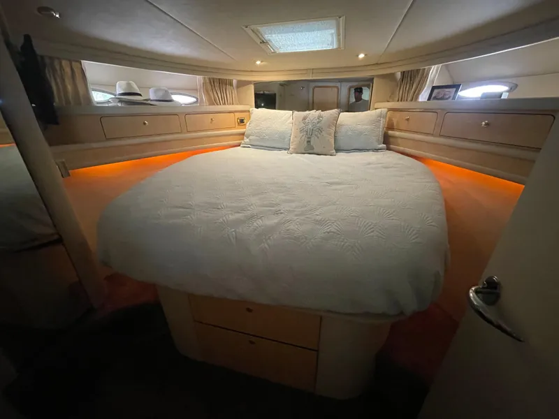 Slide: The Image of Luxurious bedroom interior of 2001 Sea Ray 480 Sedan Bridge yacht with ambient lighting. - 48