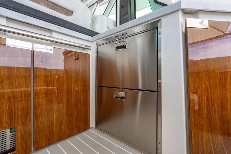 Slide: The Image of Luxurious interior of 2025 Tiara Yachts 48 LS with sleek wood and stainless steel finishes. - 25