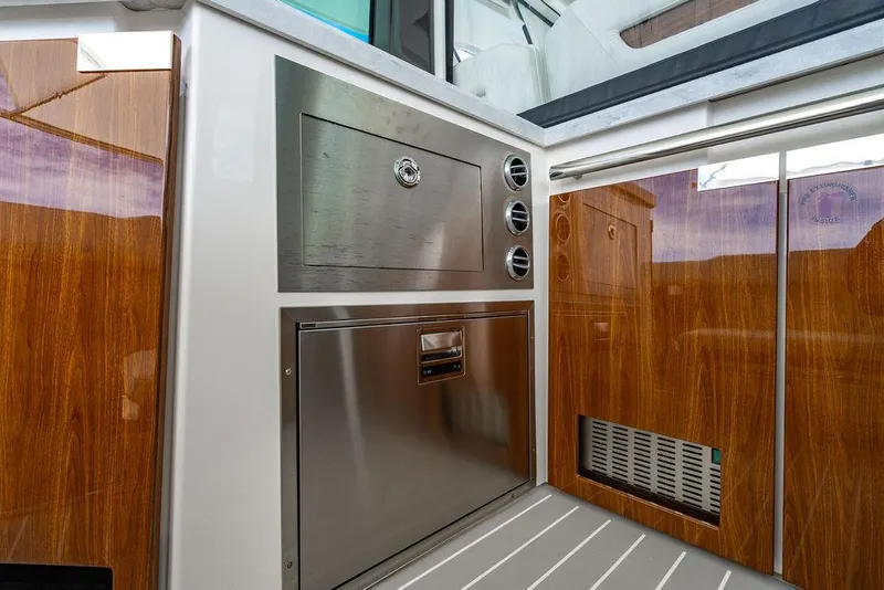 Slide: The Image of 2025 Tiara Yachts 48 LS interior with sleek wood and stainless steel finishes. - 26