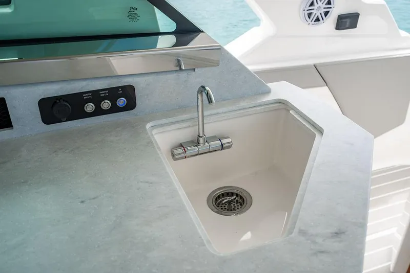 Slide: The Image of Luxury yacht sink area on 2025 Tiara Yachts 48 LS, featuring modern design and controls. - 28