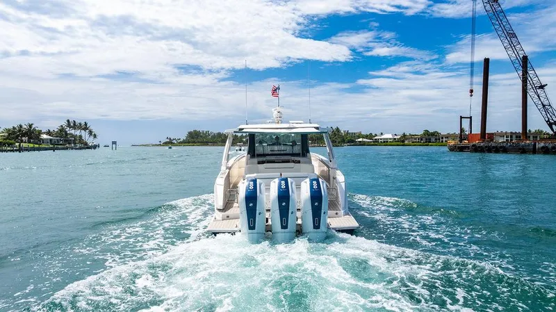 Slide: The Image of 2025 Tiara Yachts 48 LS cruising on a sunny day with triple outboard engines. - 3