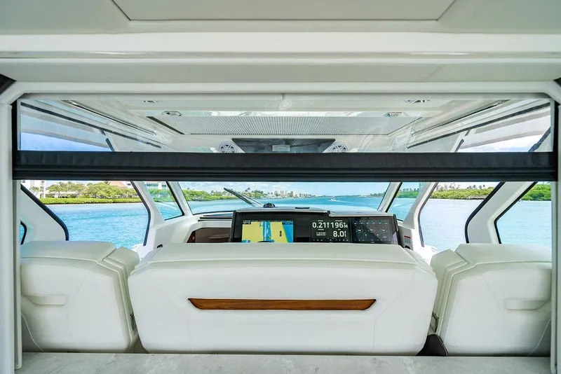 Slide: The Image of Interior view of 2025 Tiara Yachts 48 LS, featuring modern dashboard and luxurious seating. - 31