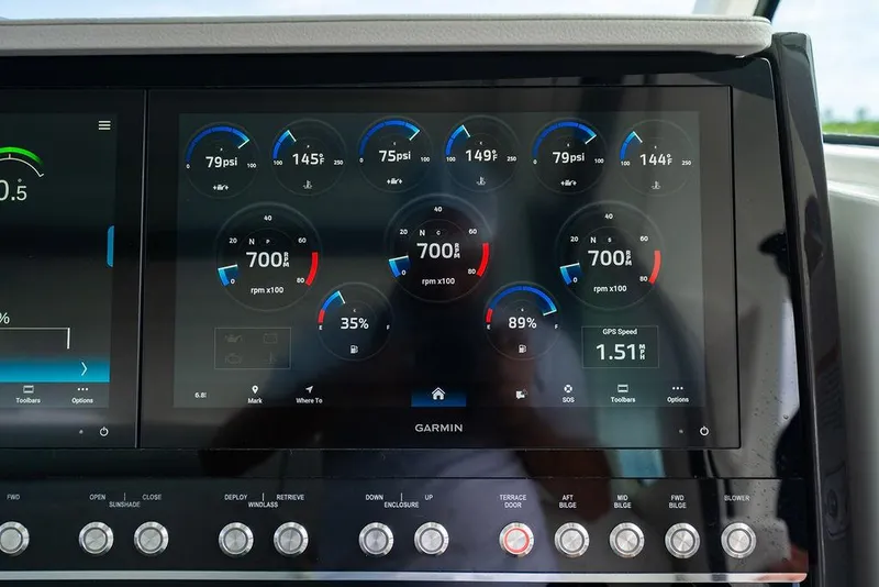 Slide: The Image of Dashboard of 2025 Tiara Yachts 48 LS with Garmin display showing engine metrics. - 36