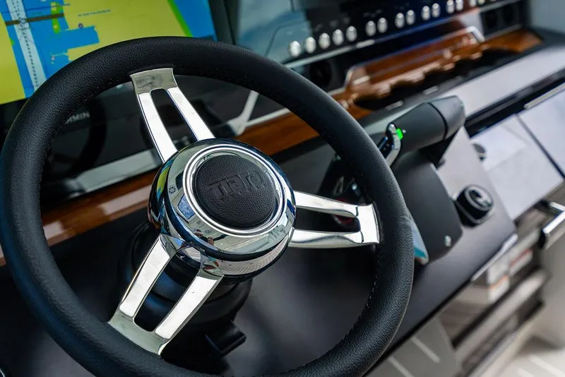 Slide: The Image of Steering wheel of 2025 Tiara Yachts 48 LS, featuring modern navigation controls. - 39