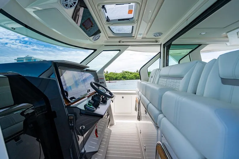 Slide: The Image of Interior of 2025 Tiara Yachts 48 LS, featuring luxurious seating and modern helm controls. - 41