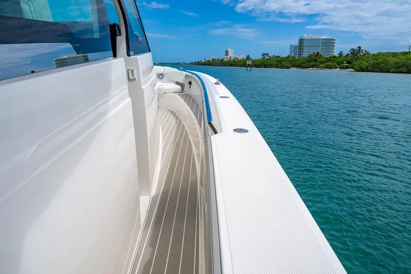 Slide: The Image of 2025 Tiara Yachts 48 LS cruising on a serene waterway with clear skies. - 42