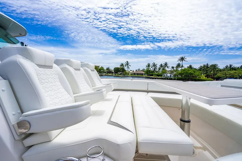Slide: The Image of Luxurious seating on 2025 Tiara Yachts 48 LS, with tropical backdrop and blue sky. - 46
