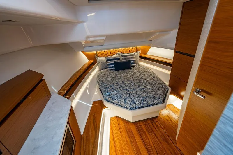 Slide: The Image of Luxurious cabin interior of 2025 Tiara Yachts 48 LS with elegant wood finishes. - 49