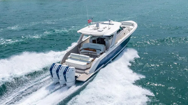 Slide: The Image of 2025 Tiara Yachts 48 LS cruising on open water, showcasing powerful engines and sleek design. - 8