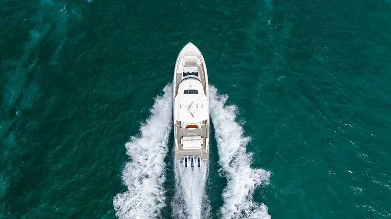 Slide: The Image of 2025 Tiara Yachts 48 LS cruising on turquoise ocean waters, aerial view. - 9