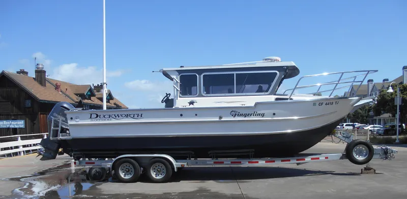 The Image of 2015 Duckworth 26’ Offshore boat on trailer, side view, clear sky background. - 0