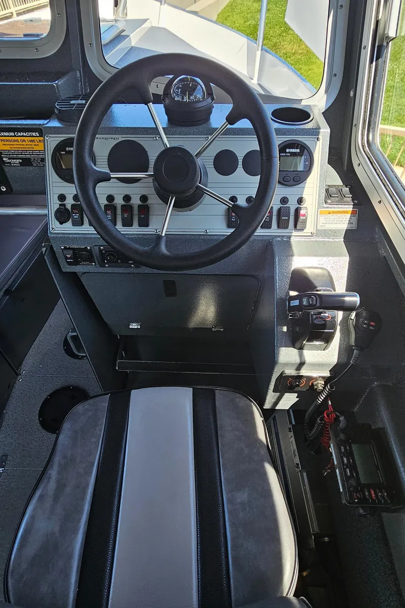 Slide: The Image of Cockpit of 2015 Duckworth 26’ Offshore boat with steering wheel and control panel. - 12