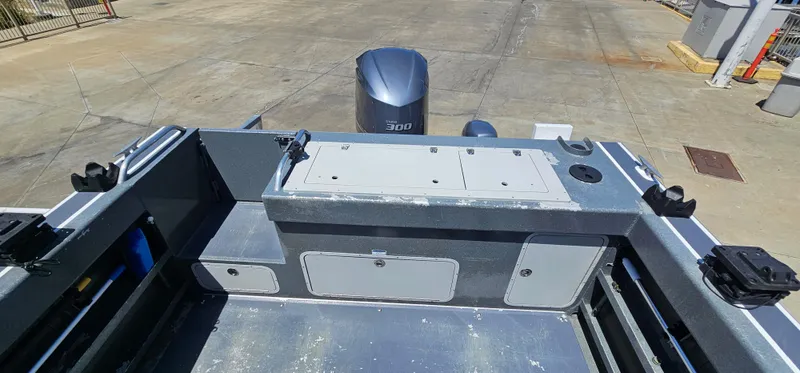 Slide: The Image of 2015 Duckworth 26’ Offshore boat deck with storage compartments and outboard motor. - 17