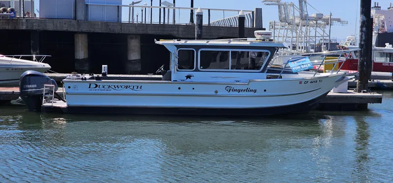 Slide: The Image of 2015 Duckworth 26’ Offshore boat docked, side view, with Yamaha outboard motor. - 2