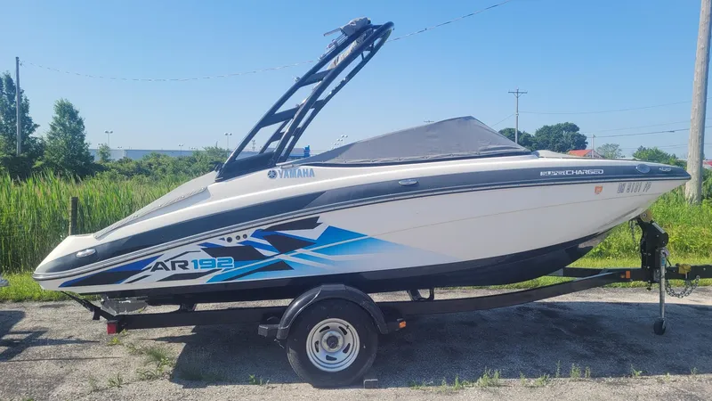 Slide: The Image of 2016 Yamaha AR192 boat on trailer, parked outdoors, side view. - 1