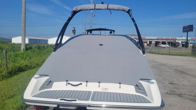 Slide: The Image of 2016 Yamaha AR192 boat with cover, parked outdoors on a sunny day. - 2