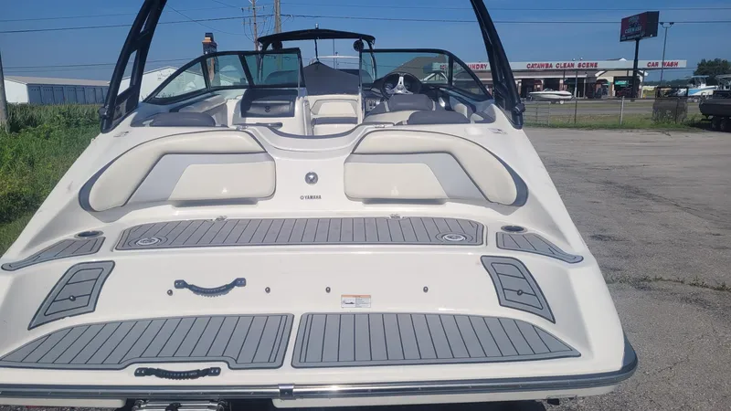 Slide: The Image of 2016 Yamaha Boats AR192, rear view, parked outdoors, showcasing sleek design and spacious seating. - 5